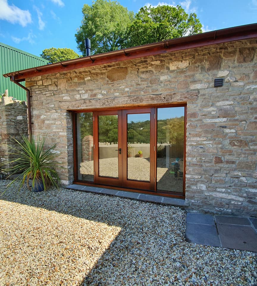 Hardwood French doors set into the original opening.